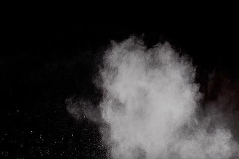 Bizarre forms of white powder explosion cloud against black background.Whit.. Stock Photos