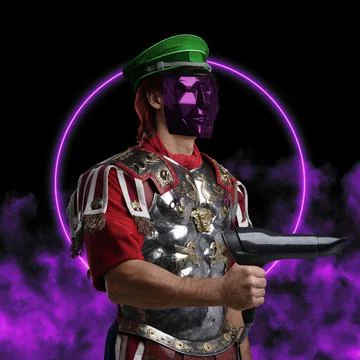 Bizarre guy dressed in armor and mask holding hair dryer 库存照片