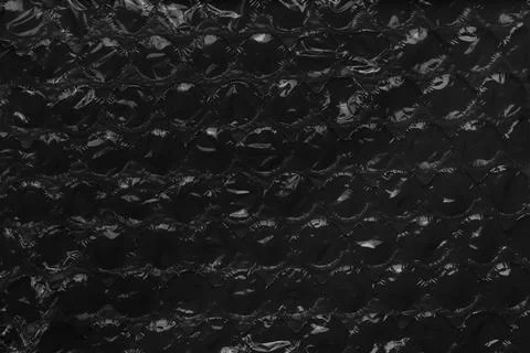 Black abstract background of packaging bubble wrap. Dark soft surface Foto stock