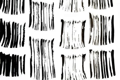 Black abstract brush strokes pattern and splashes of paint on paper. Grunge art Stock Photos