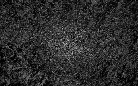 Black abstract textured background creating dramatic and grunge effect Stock Photos