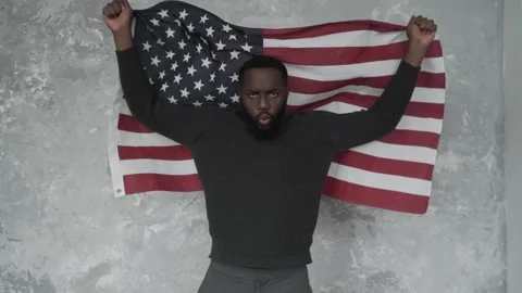 Black activist, African American protests with the American flag, shouts "USA" Stock Footage 132451853