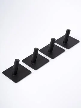 Black adhesive wall hooks diagonal set Stock Photos