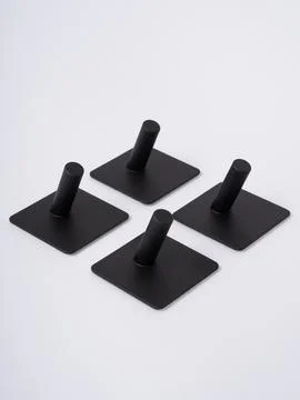 Black adhesive wall hooks flat lay Stock Photos