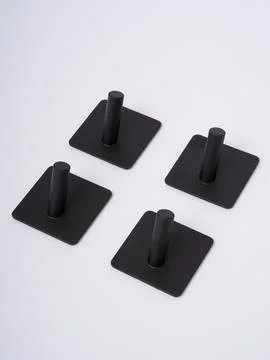 Black adhesive wall hooks set of four Stock Photos