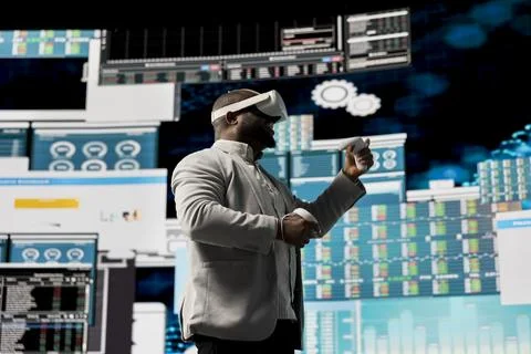 Black administrator reviewing big data with virtual reality headset Stock Photos