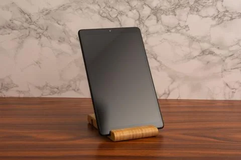 Black advanced smart home control panel mounted on a wooden base and light .. Stock Photos