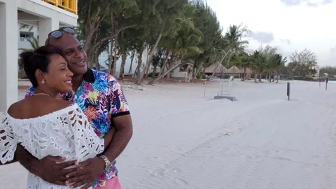 Black African American Caribbean in love couple hug and embrace on beach Stock Footage