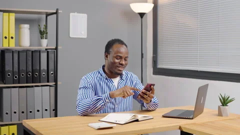 Black African American Man Using Smartphone at office Video stock 276834894