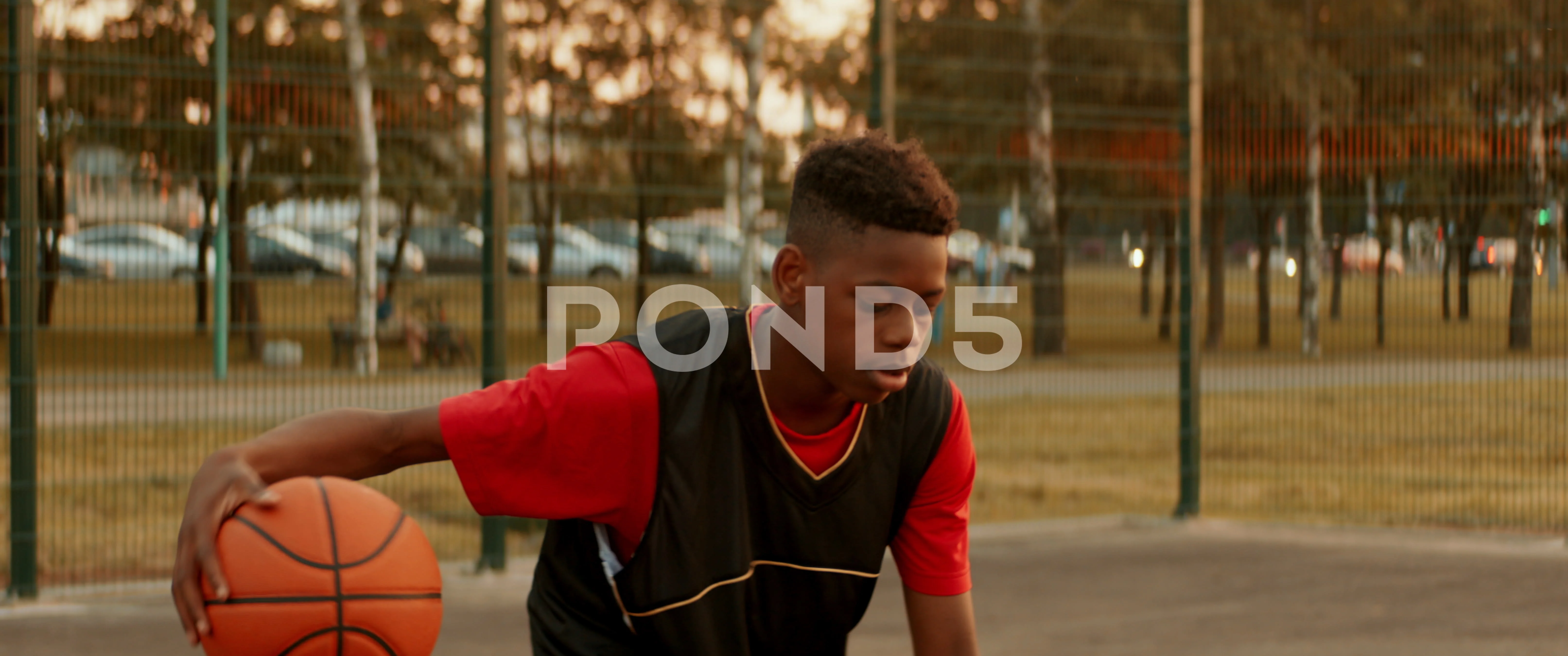 black child playing basketball