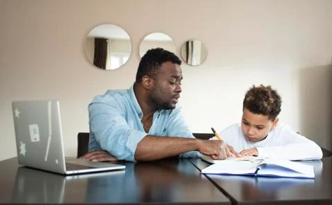 Black african american tutor teaching  a boy Stock Photos