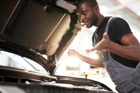 Black african auto mechanic does not understand how to troubleshoot the machine Stock Photos