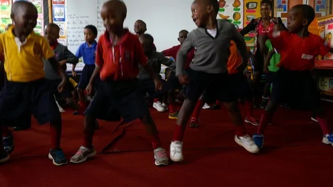 Black African boys are practicing dance and jumping up and down Stock Footage 98090358