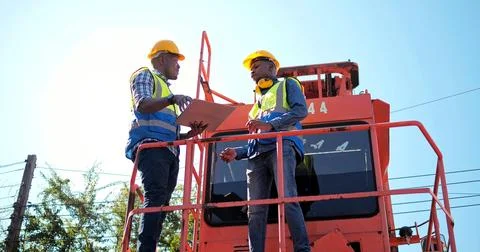 Black African engineer control checking container at cargo for import and export Stock Photos