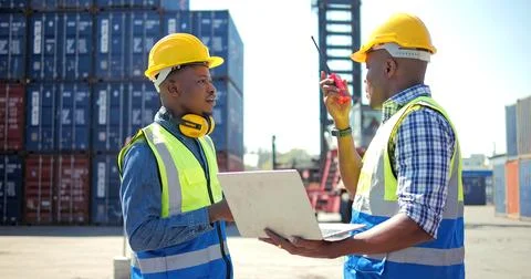 Black African engineer control checking container at cargo for import and export Stock Photos