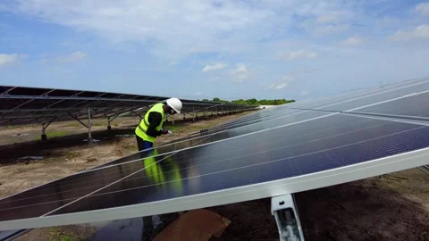 Black African male engineer testing the efficiency of a photovoltaic solar Stock Footage 247547111