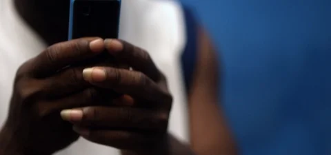 Black African man checking his mobile phone Stock Footage 105376931