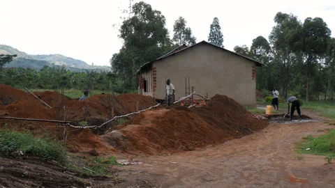 Black African Mans working on construction sites on a rainy day. Uganda. Stock Footage 194530322