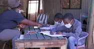 Black African Woman Home Schooling Young Children At Their Dilapidated Home Stock Footage