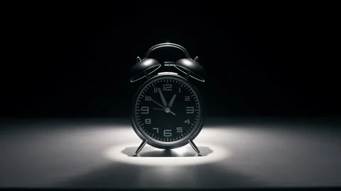 Black alarm clock on a black background. Stock Footage 340250016