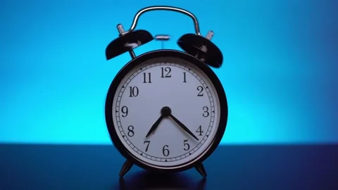 Black alarm clock on a blue background. Stock Footage 132352006