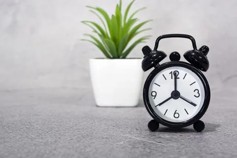 Black alarm clock isolated. The clock set at 8 o'clock. Deadline concept. Foto stock