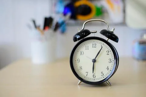 Black alarm clock on the table Stock Photos