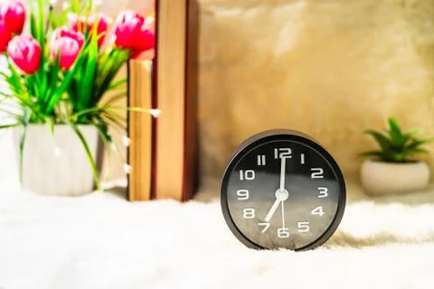 Black alarm clock on table Stock Photos
