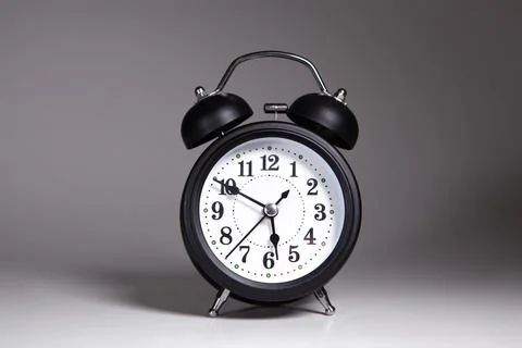 Black alarm clock with white background. Stock Photos