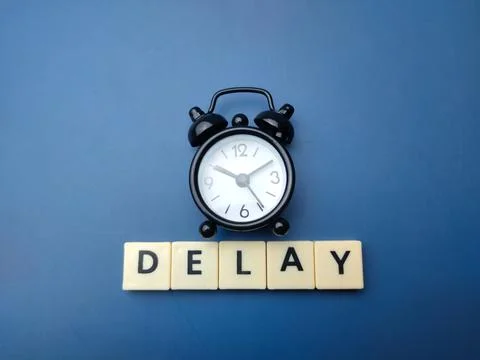 Black alarm clock with the word DELAY Stock Illustration