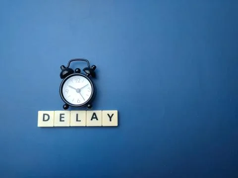 Black alarm clock with the word DELAY Stock Illustration