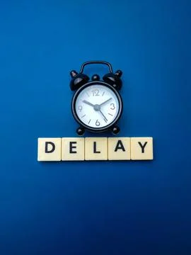 Black alarm clock with the word DELAY Stock Illustration