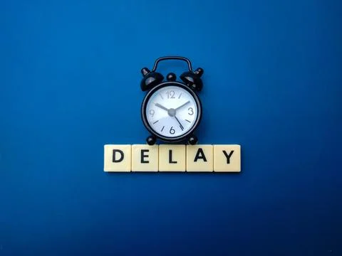 Black alarm clock with the word DELAY Stock Illustration