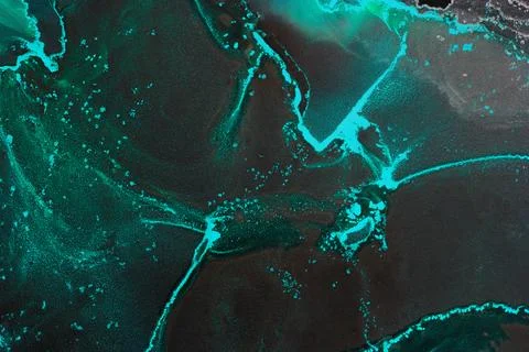 Black alcohol ink forms abstract patterns on canvas in creative art space Stock Photos
