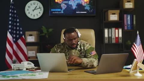 Black American intelligence officer coordinates military mission on laptops Stock Footage 342148814