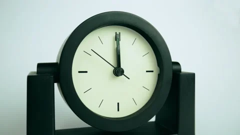 Black analog clock without numbers ticking midnight or noon Stock Footage