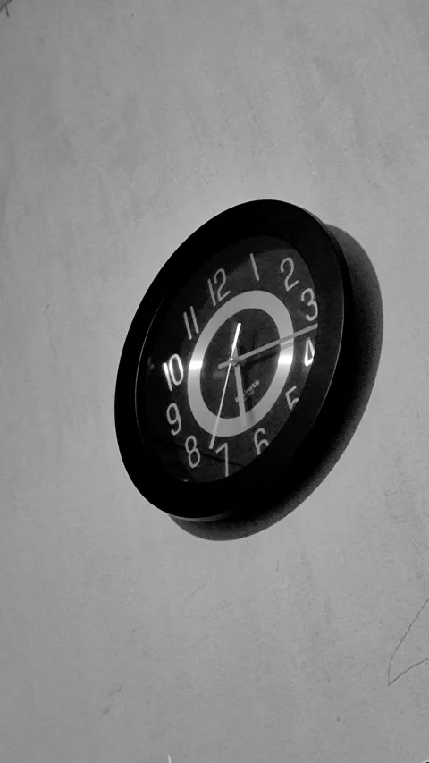 Black analog wall clock on wall Stock Footage 343617627