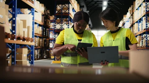 Black and asian workers managing the order fulfillment process in shipping area Stock Footage 313090589