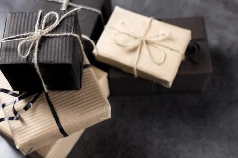 Black and brown gift boxes for holidays gift on dark texture background. Stock Photos
