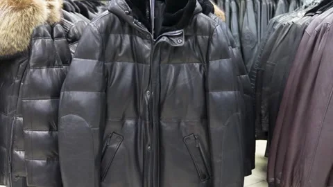 Black and brown leather jackets on a hanger in a store Stock Footage 271025329
