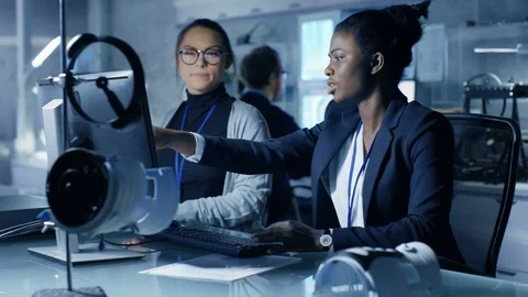 Black and Caucasian Female Scientists Working on a Computer Stock Footage