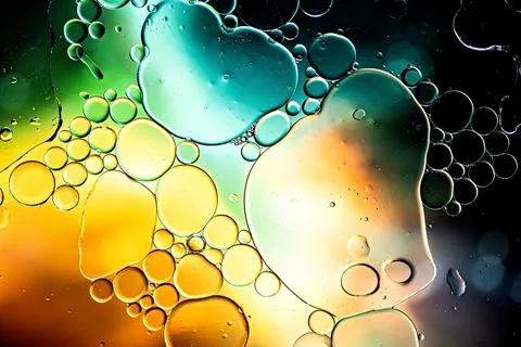 Black and gold abstract pattern made with oil bubbles on water Stock Photos
