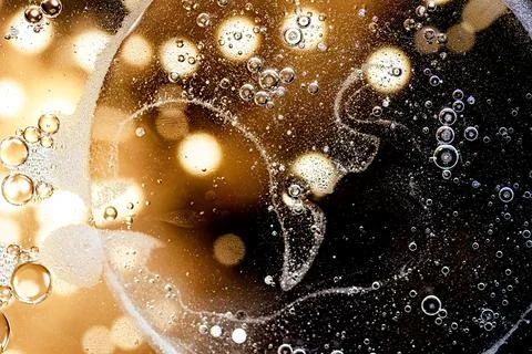 Black and gold abstract pattern made with oil bubbles on water Stock Photos
