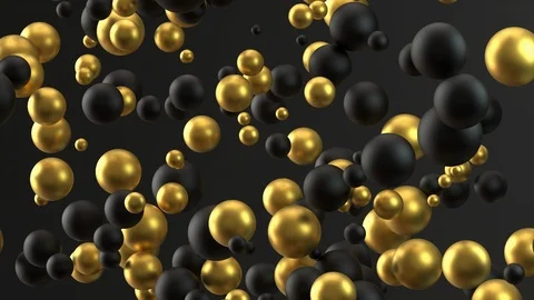 Black and gold beads of different sizes scatter on a black background Stock Footage 125976330