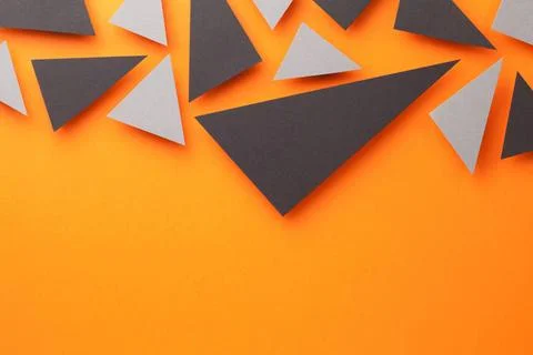Black And Gray Triangular Shapes On Orange Black and gray triangular shape... Stock Photos