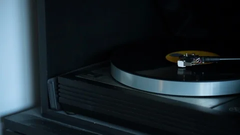 Black and grey record player spins Stock Footage 98739438