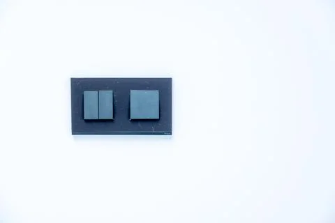 A black and grey switch with two buttons on it Stock Photos