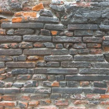 Black and orange brick texture. Stock Photos
