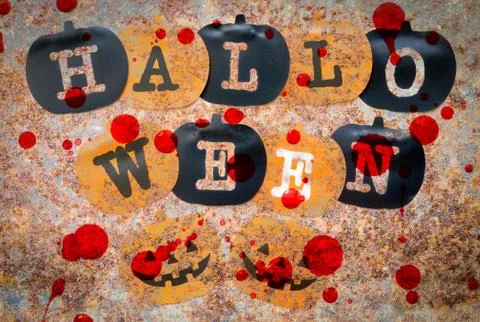Black and orange pumpkins on rust stains texture background Foto stock