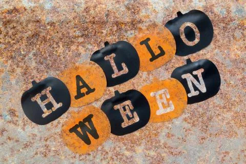Black and orange pumpkins on rust stains texture background Foto stock